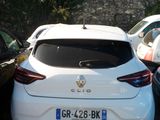 a small white car that is parked on the side of the road