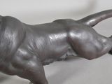 a statue of a dog that is laying down on a table