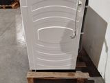 a white toilet sitting on a pallet in a warehouse