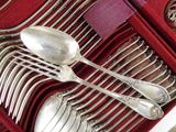 silverware in a red box with a purple napkin and a silver spoon