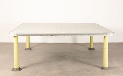 an image of a white table with yellow legs in a room