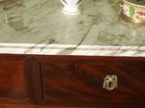 a white vase sitting on top of a marble counter top