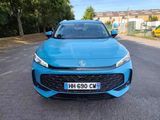 a blue car parked on the side of the road