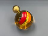 a glass ball with a red and yellow design on it
