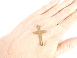 a person ' s hand with a cross on it