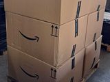 boxes stacked on a pallet in a warehouse with an arrow pointing up