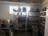 a room with a lot of shelves and a refrigerator