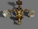 a gold colored chandelier with three lights on it