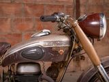 a motorcycle that is parked in front of a brick wall