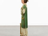 a statue of a man in a green robe and hat with a cane