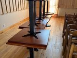many chairs and tables in a room with wooden walls