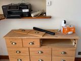 a wooden dresser with a baseball bat on top of it