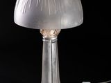 a glass lamp that is sitting on a table