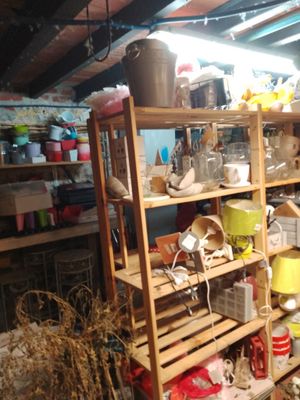 a wooden shelf filled with lots of items in a room