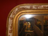 a reflection of a clock in a mirror on the wall