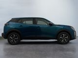 a blue suv parked in a room with a white wall