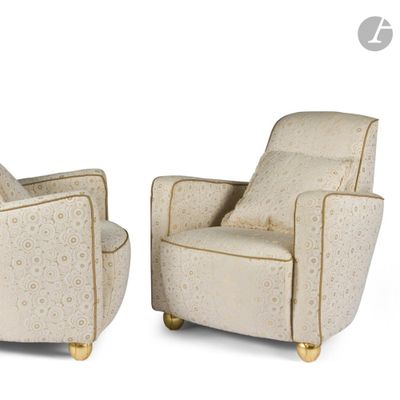 pair of beige upholstered armchairs with gold legs