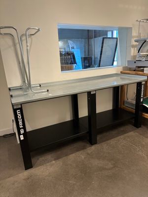 a glass table with a mirror on it in a room