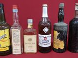 several bottles of alcohol are lined up on a red table