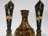 three vases sitting next to each other on a white surface
