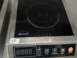 a stove top with a digital display on it in a kitchen