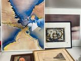 a desk with a lot of art and pictures on it