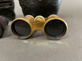 two pairs of binoculars sitting next to each other on top of a table