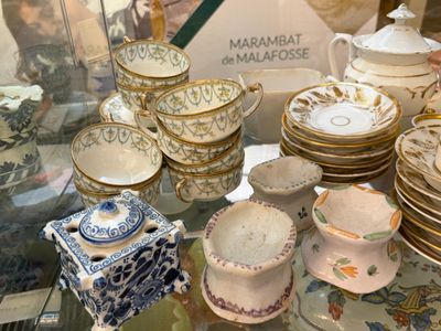 une table en verre sur laquelle sont posées de nombreuses assiettes et tasses