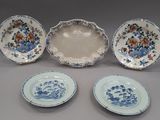 four pieces of blue and white plates with floral designs on them