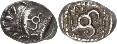 a close up of a coin with a skull on it