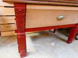 a wooden table with a drawer on top of it