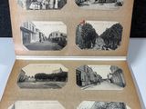 an old black and white photo of an open book with pictures of buildings