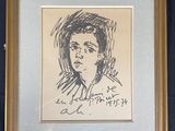 a drawing of a woman ' s face in a gold frame