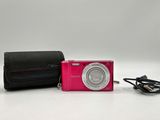 a pink camera and a black case on a white surface