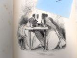 la photo d'un livre sur lequel figure l'image d'une femme et d'un homme assis à une table sur laquelle se trouve une feuille de papier