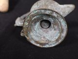 a close up of a metal object on a black surface