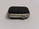 an apple watch sitting on top of a white table next to a cup of coffee