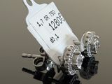 a pair of earrings sitting on a table with a price tag