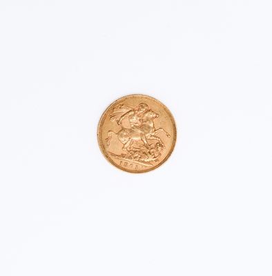 a close up of a gold coin on a white surface