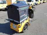 a yellow motorcycle with a black box on the back of it