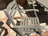 two chairs and a table on a tiled patio