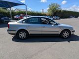 a silver car that is parked in a parking lot