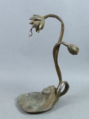 brass plate with a flower on it on a white background