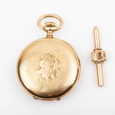 an image of a gold pocket watch sitting next to a tie bar