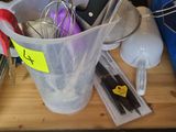 a plastic container with scissors and other items in it