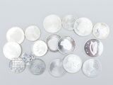 several different types of coins are arranged on a white surface