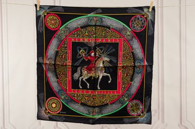 a tapestry hanging on a clothes line with a picture of a man on a horse