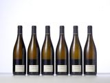 six bottles of wine lined up in a row on a table