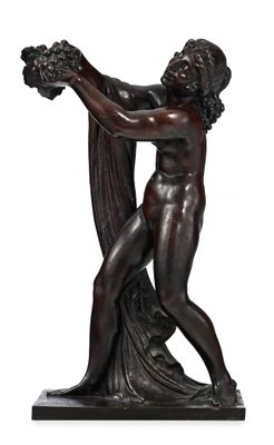 a bronze statue of a man holding a bunch of grapes