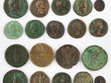 a group of ancient coins on display on a white surface